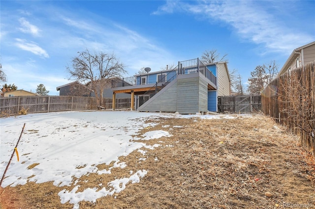 snow covered property with a fenced backyard