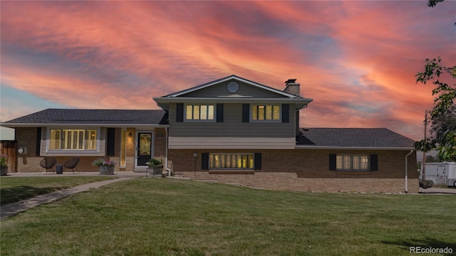 9629 Yukon Ct, Westminster, CO 80021 - split level home featuring brick siding, a chimney, and a front lawn
