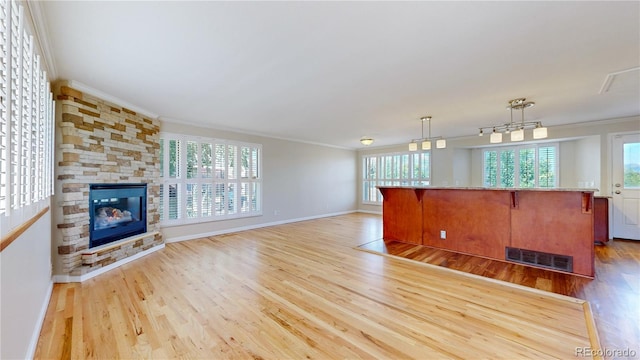 9629 Yukon Ct, Westminster, CO 80021 - unfurnished living room with crown molding, wood finished floors, and a fireplace