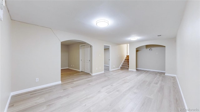 9629 Yukon Ct, Westminster, CO 80021 - empty room with stairs, light wood-type flooring, and arched walkways
