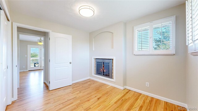 9629 Yukon Ct, Westminster, CO 80021 - unfurnished living room featuring light wood-style flooring and a glass covered fireplace
