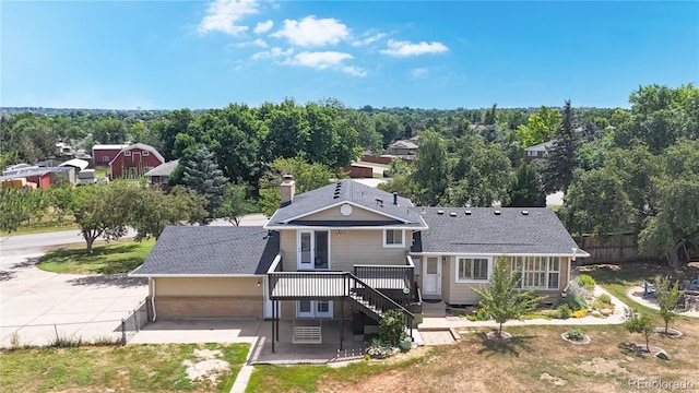 9629 Yukon Ct, Westminster, CO 80021 - back of property featuring driveway, a deck, a patio, a chimney, and roof with shingles