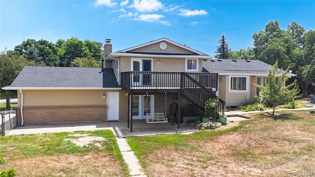 9629 Yukon Ct, Westminster, CO 80021 - back of house featuring a patio area, a deck, brick siding, a chimney, and a yard