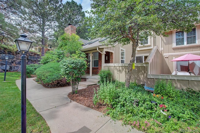 2713 W Long Dr Unit C, Littleton, CO 80120 - obstructed view of property featuring a chimney and brick siding