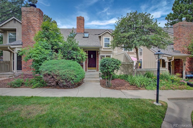 2713 W Long Dr Unit C, Littleton, CO 80120 - view of front of home with a chimney, a shingled roof, and brick siding