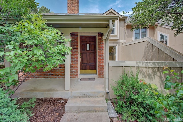 2713 W Long Dr Unit C, Littleton, CO 80120 - doorway to property with a chimney and brick siding