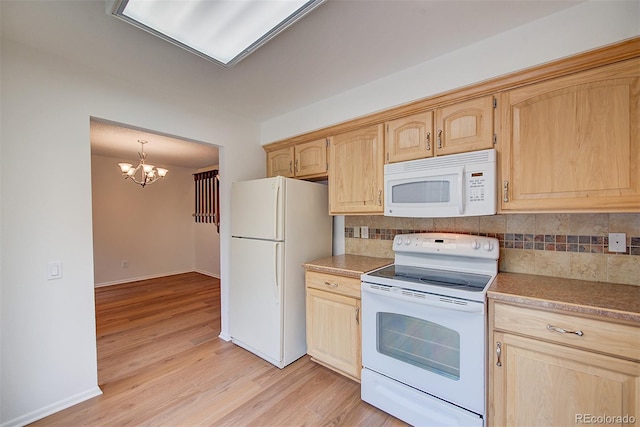 2713 W Long Dr Unit C, Littleton, CO 80120 - kitchen with white appliances, light brown cabinetry, decorative backsplash, and a chandelier