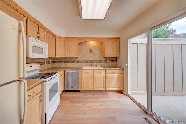 2713 W Long Dr Unit C, Littleton, CO 80120 - kitchen featuring white appliances, light brown cabinetry, light wood-style flooring, and backsplash