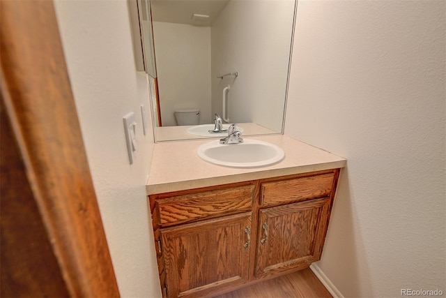 2713 W Long Dr Unit C, Littleton, CO 80120 - half bathroom featuring vanity and wood finished floors