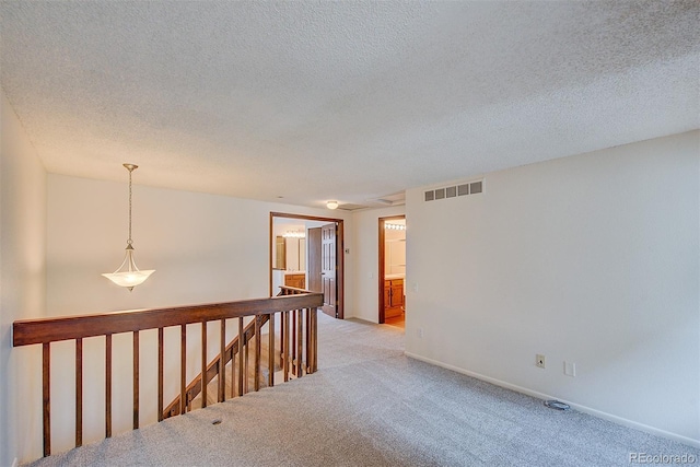2713 W Long Dr Unit C, Littleton, CO 80120 - unfurnished room with light colored carpet and a textured ceiling