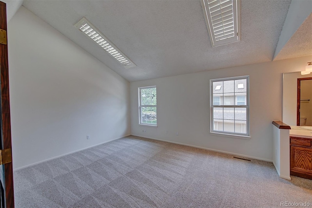 2713 W Long Dr Unit C, Littleton, CO 80120 - empty room with lofted ceiling, light colored carpet, and a textured ceiling