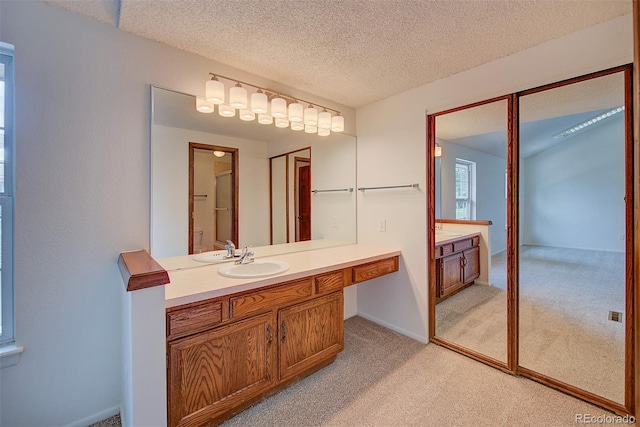 2713 W Long Dr Unit C, Littleton, CO 80120 - bathroom with vanity, a textured ceiling, and carpet
