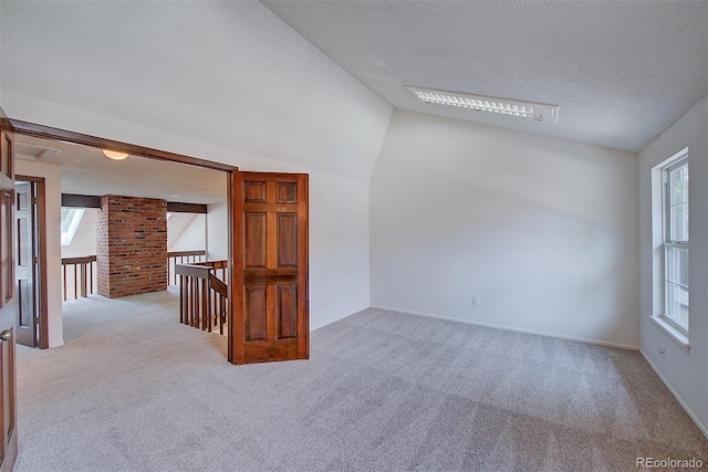 2713 W Long Dr Unit C, Littleton, CO 80120 - carpeted spare room featuring a textured ceiling and lofted ceiling