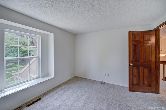 2713 W Long Dr Unit C, Littleton, CO 80120 - spare room featuring carpet flooring and a textured ceiling