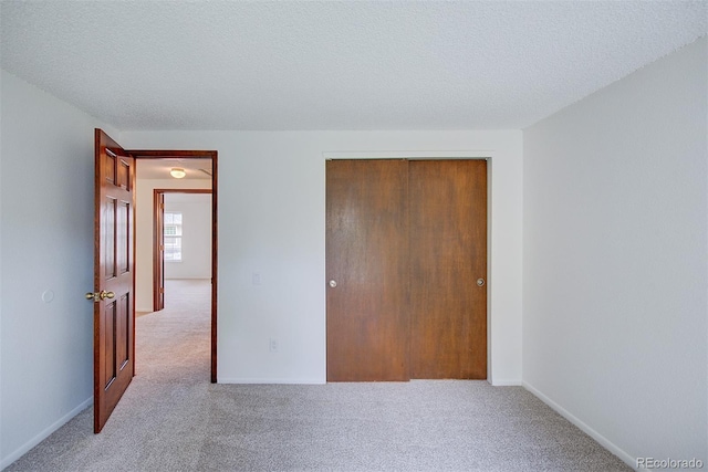 2713 W Long Dr Unit C, Littleton, CO 80120 - unfurnished bedroom with carpet floors, a closet, and a textured ceiling