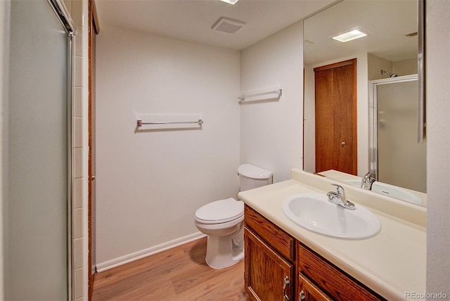 2713 W Long Dr Unit C, Littleton, CO 80120 - full bathroom featuring wood finished floors, a shower with shower door, and vanity