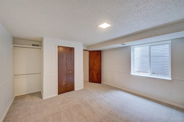 2713 W Long Dr Unit C, Littleton, CO 80120 - unfurnished bedroom with carpet flooring, a textured ceiling, and a closet