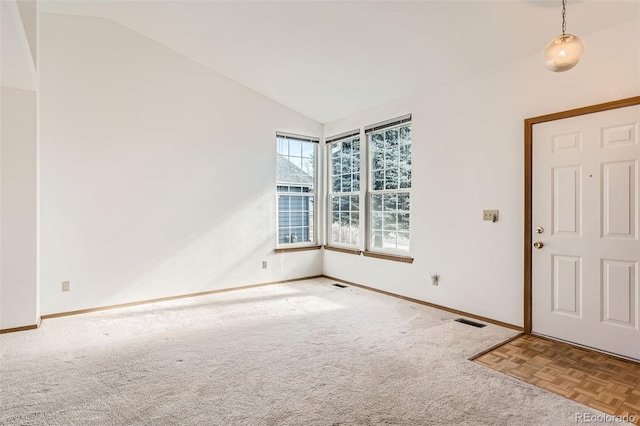 entrance foyer featuring vaulted ceiling and light colored carpet