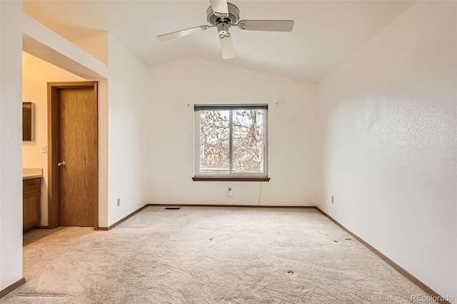 carpeted empty room featuring lofted ceiling and ceiling fan