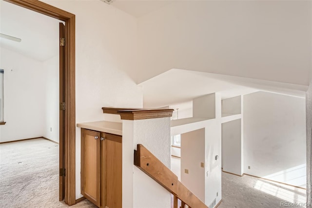 hallway featuring light colored carpet