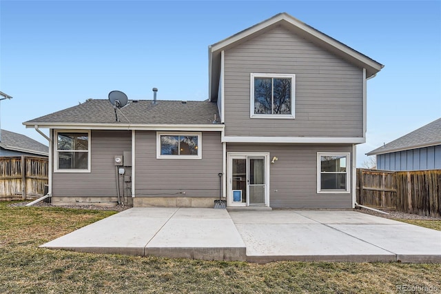 back of house with a yard and a patio