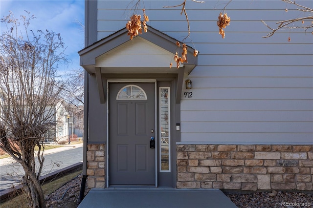 entrance to property with stone siding