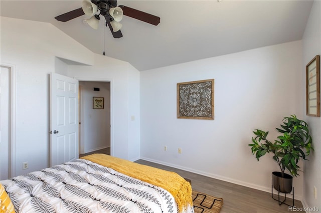 bedroom featuring a ceiling fan, lofted ceiling, wood finished floors, and baseboards