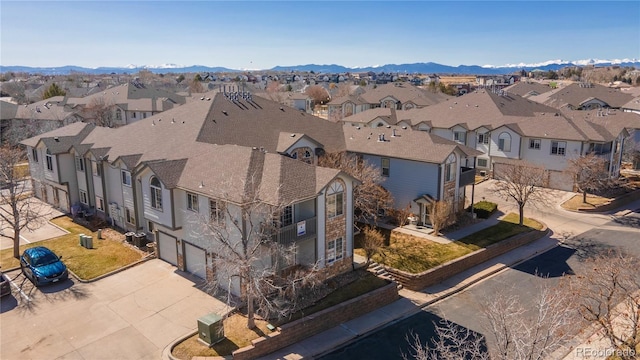 birds eye view of property with a mountain view and a residential view