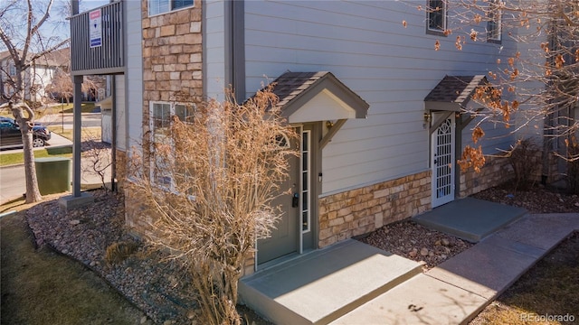 doorway to property featuring stone siding