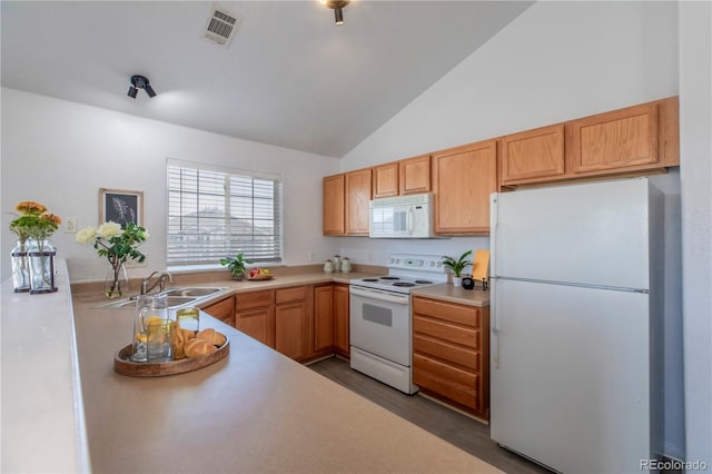 3260 E 103rd Pl Unit 912, Thornton, CO 80229 - kitchen featuring white appliances, a sink, light countertops, wood finished floors, and high vaulted ceiling