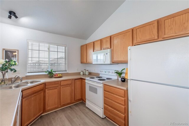 3260 E 103rd Pl Unit 912, Thornton, CO 80229 - kitchen with white appliances, a sink, vaulted ceiling, light wood-type flooring, and light countertops