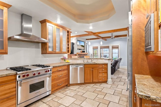 848 S Emerson St, Denver, CO 80209 - kitchen with stainless steel appliances, wall chimney exhaust hood, a peninsula, a sink, and recessed lighting