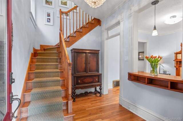 848 S Emerson St, Denver, CO 80209 - stairs featuring wood finished floors, ornamental molding, and baseboards