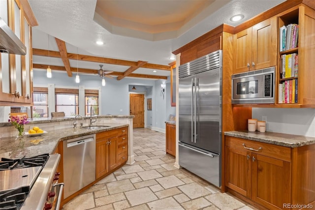 848 S Emerson St, Denver, CO 80209 - kitchen featuring built in appliances, a sink, wall chimney exhaust hood, recessed lighting, and brown cabinetry