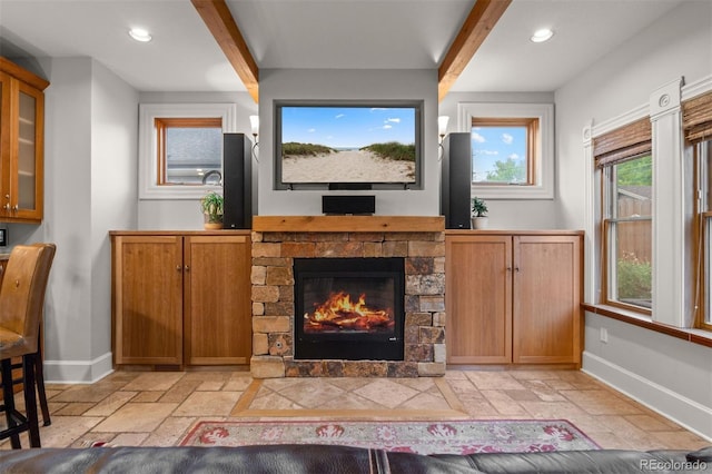 848 S Emerson St, Denver, CO 80209 - living area with beamed ceiling, baseboards, recessed lighting, a fireplace, and stone tile floors