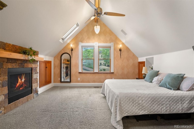 848 S Emerson St, Denver, CO 80209 - carpeted bedroom featuring lofted ceiling, a fireplace, a ceiling fan, baseboards, and a skylight