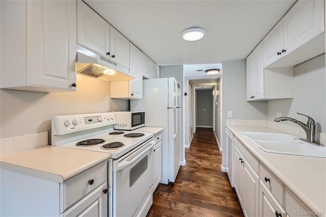 kitchen with white appliances, dark hardwood / wood-style flooring, sink, and white cabinetry