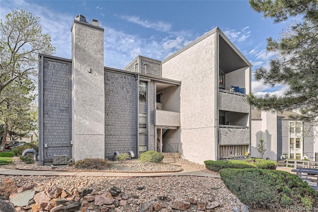 exterior space with central AC and a balcony