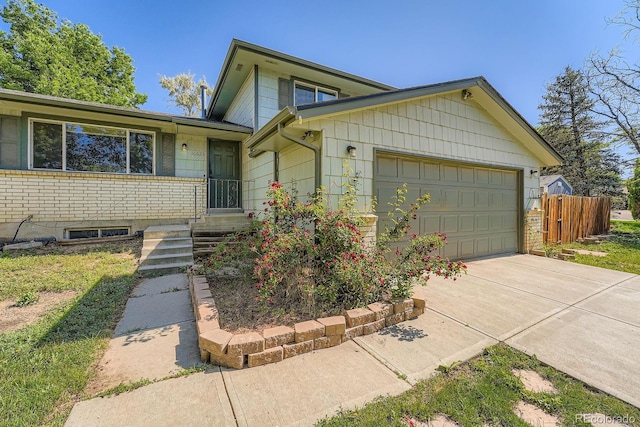 16623 E Asbury Pl, Aurora, CO 80013 - tri-level home featuring a garage and concrete driveway