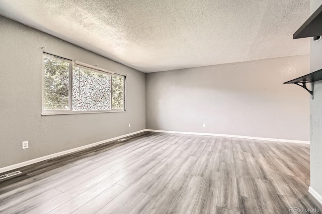 16623 E Asbury Pl, Aurora, CO 80013 - empty room featuring wood finished floors and a textured ceiling