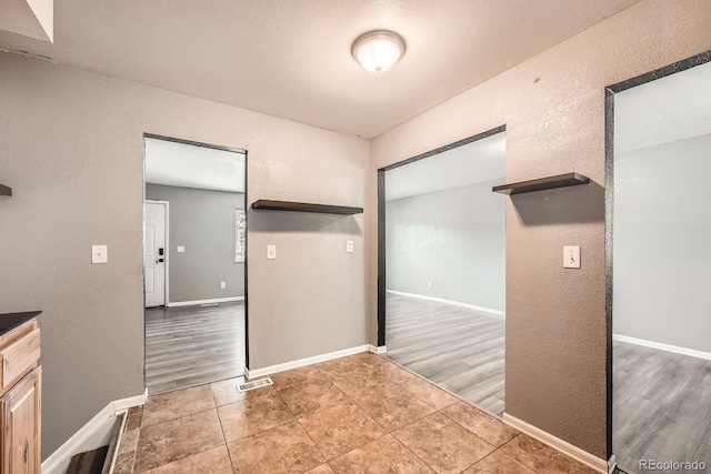 16623 E Asbury Pl, Aurora, CO 80013 - unfurnished bedroom featuring a textured wall and tile patterned floors