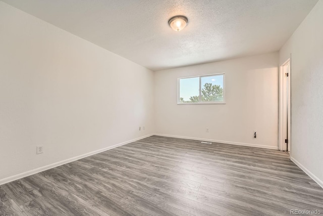 16623 E Asbury Pl, Aurora, CO 80013 - spare room with dark wood-style flooring and a textured ceiling