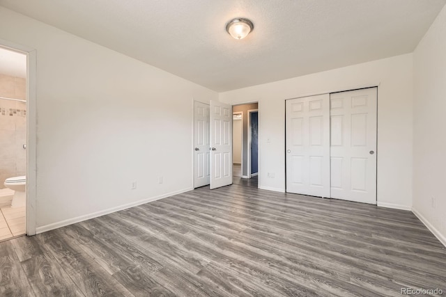 16623 E Asbury Pl, Aurora, CO 80013 - unfurnished bedroom with wood finished floors, ensuite bath, and a closet