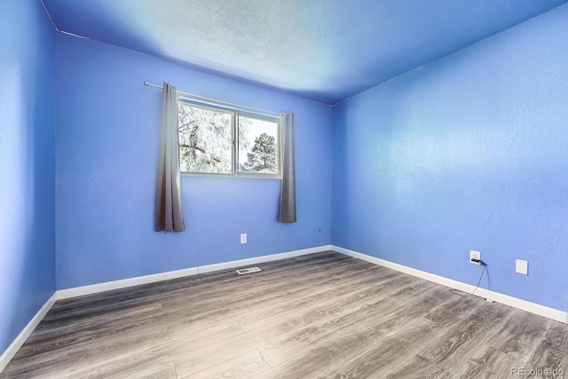 16623 E Asbury Pl, Aurora, CO 80013 - spare room featuring wood finished floors and a textured ceiling