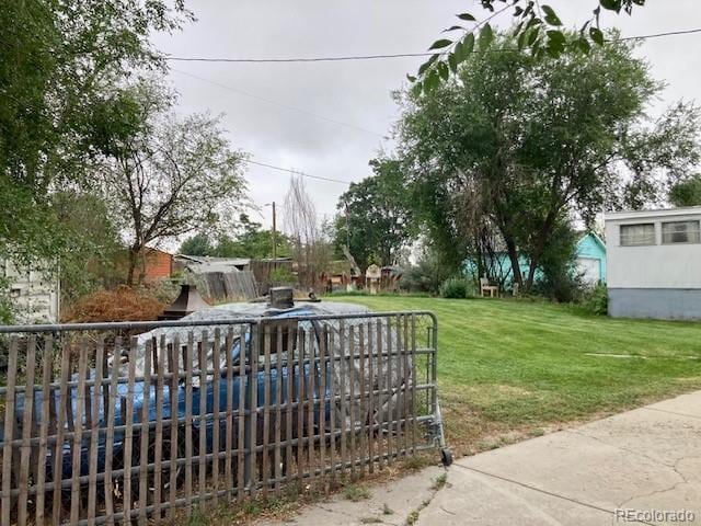 view of gate with a yard