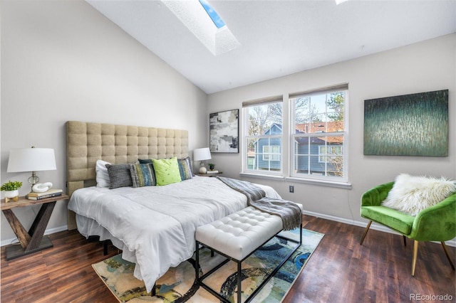 bedroom with baseboards, lofted ceiling with skylight, and wood finished floors