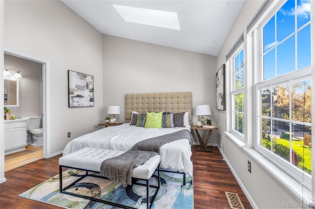 bedroom with a skylight, wood finished floors, high vaulted ceiling, visible vents, and baseboards