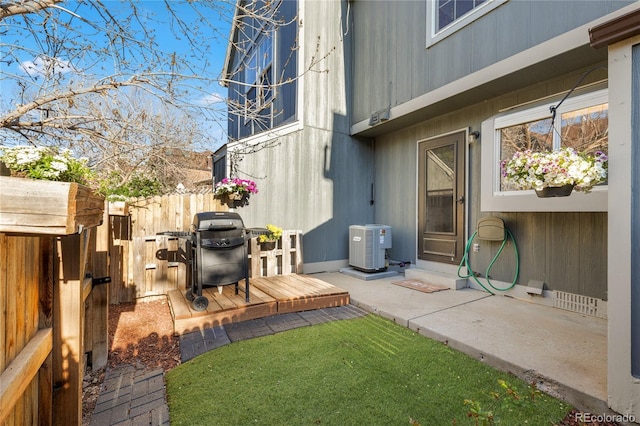 view of yard with central AC unit and fence