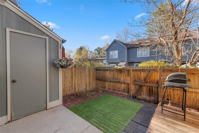 view of yard with a wooden deck and a fenced backyard