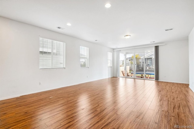 9674 Truckee St, Commerce City, CO 80022 - unfurnished living room featuring light wood finished floors, visible vents, baseboards, and recessed lighting